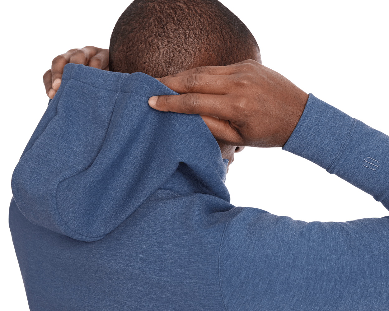 Person pulling up the hood of The Tilley Quarter-Zip Hoodie: Heathered Andover, showcasing its sleek silhouette and tonal embroidered logo on the sleeve.