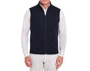 The Ashby Vest: Heathered Dark Navy, shown on a model over a white shirt, features zippered pockets and a soft brushed interior for versatile comfort.