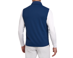 Man wearing a Holderness & Bourne Men’s Blue Golf Vest over a white shirt on a white background