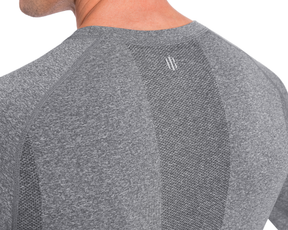 Close-up of The Carr T-Shirt in heathered gray, featuring a seamless design with mesh-like and smooth textures, plus a logo below the neck.