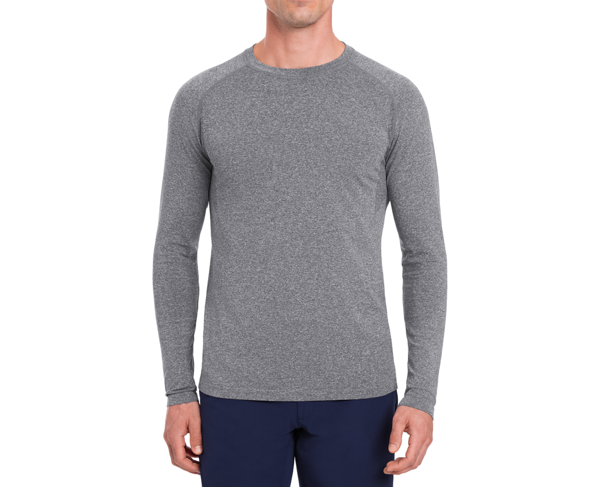 The Carr T-Shirt: Heathered Gray, shown on a person, features long sleeves and a form-fitting design, ideal for active and casual wear.