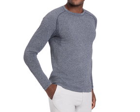 Person wearing The Carr T-Shirt: Heathered Navy, a fitted, long-sleeve shirt with advanced moisture-wicking and four-way stretch, hand casually in pocket.