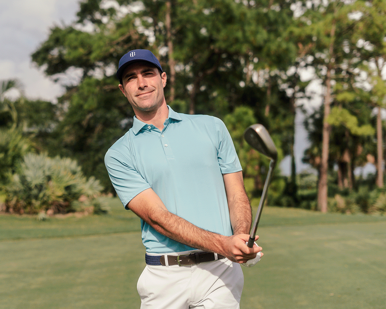 The Anderson Shirt: Harbor worn by golfer post-swing on course, showcasing its structured collar and signature fit. Ideal for comfort with jersey knit performance fabric.