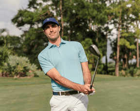 The Anderson Shirt: Harbor worn by golfer post-swing on course, showcasing its structured collar and signature fit. Ideal for comfort with jersey knit performance fabric.