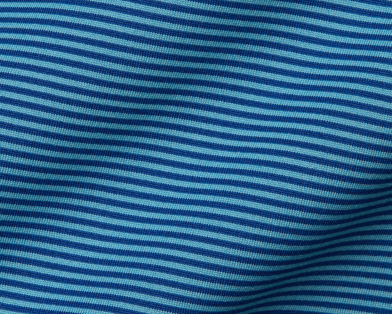 The Perkins Boys Shirt: Maidstone Blue & Harbor features striped knit fabric with light and dark blue bands, showcasing a structured spread collar and unique geometric pattern.