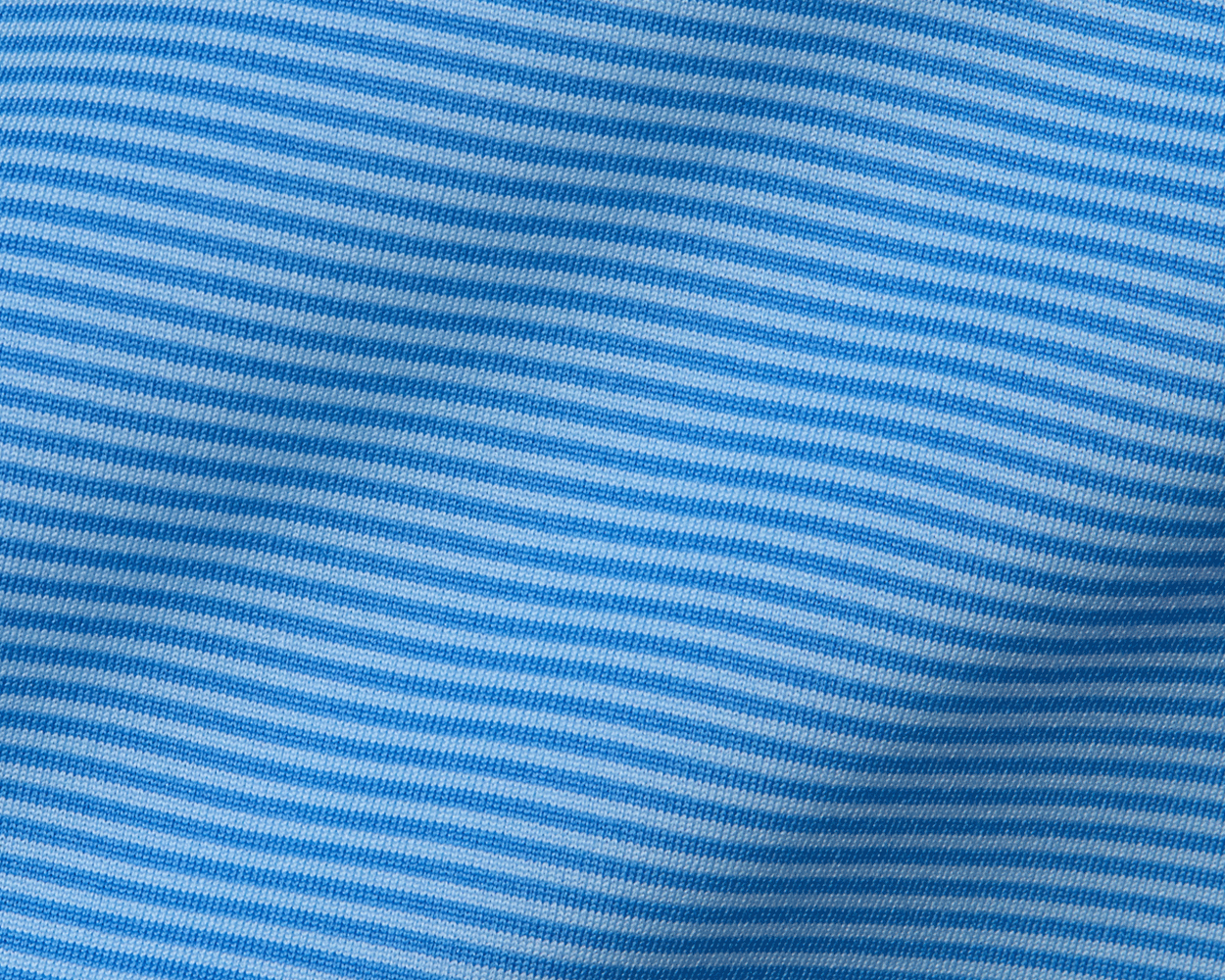Close-up of The Perkins Shirt in Horizon Blue & Vista Blue, showcasing fine knit loops, horizontal stripes, and ribbing, highlighting its performance fabric's texture and structure.