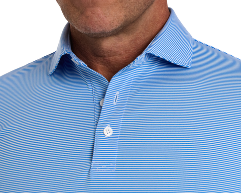 Man wearing The Perkins Shirt: Horizon Blue & White, showing a light-blue polo with fine white stripes, two-button placket, and classic collar.