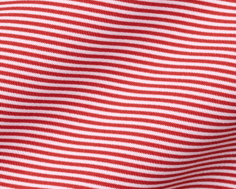 Close-up of The Perkins Shirt: Liberty Red & White, showcasing its fine knit, horizontal stripes, and gentle folds, highlighting its soft, performance fabric texture.