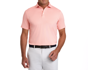 Man wearing The Perkins Shirt: Nectarine & White, a short-sleeve polo with a structured collar, paired with white pants and a dark belt.