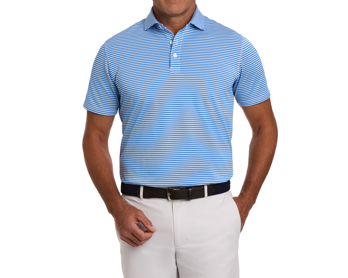 The Maxwell Shirt: Horizon Blue & White, features thin stripes, short sleeves, a structured collar, and a comfortable fit, paired with off-white trousers and a dark belt.