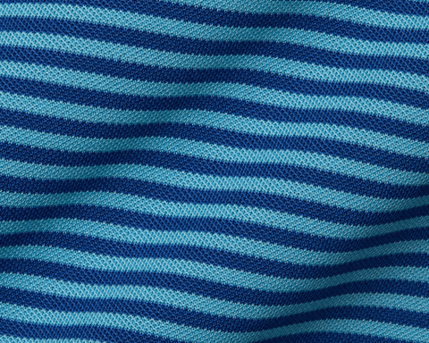 Close-up of The Maxwell Shirt: Maidstone Blue & Harbor, featuring light and dark blue striped performance pique knit, showcasing its textured and breathable fabric.