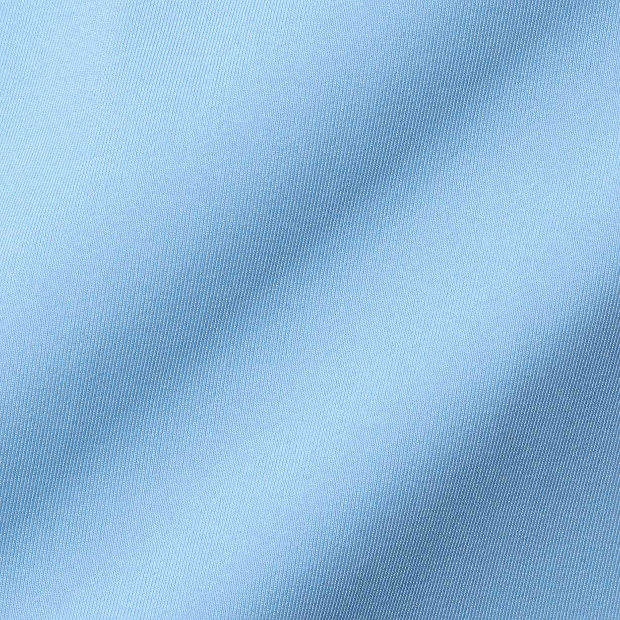 The Farrell Shirt: Vista Blue features a close-up of light blue twill weave fabric with fine diagonal ribs, highlighting its soft, draped texture.