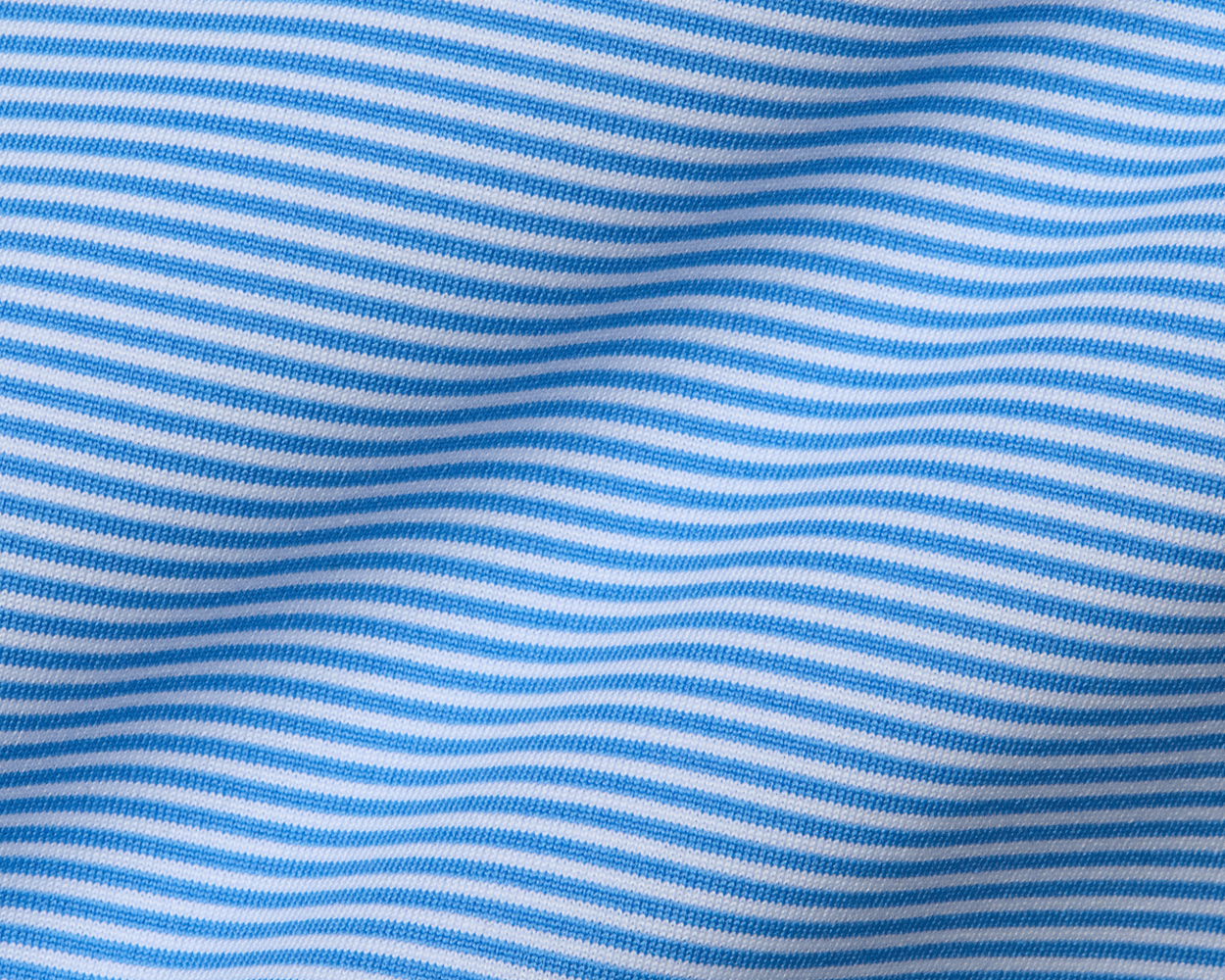 The Burke Shirt: Horizon Blue & White features fine horizontal stripes, showcasing a lightweight, breathable fabric ideal for sun protection and comfort.
