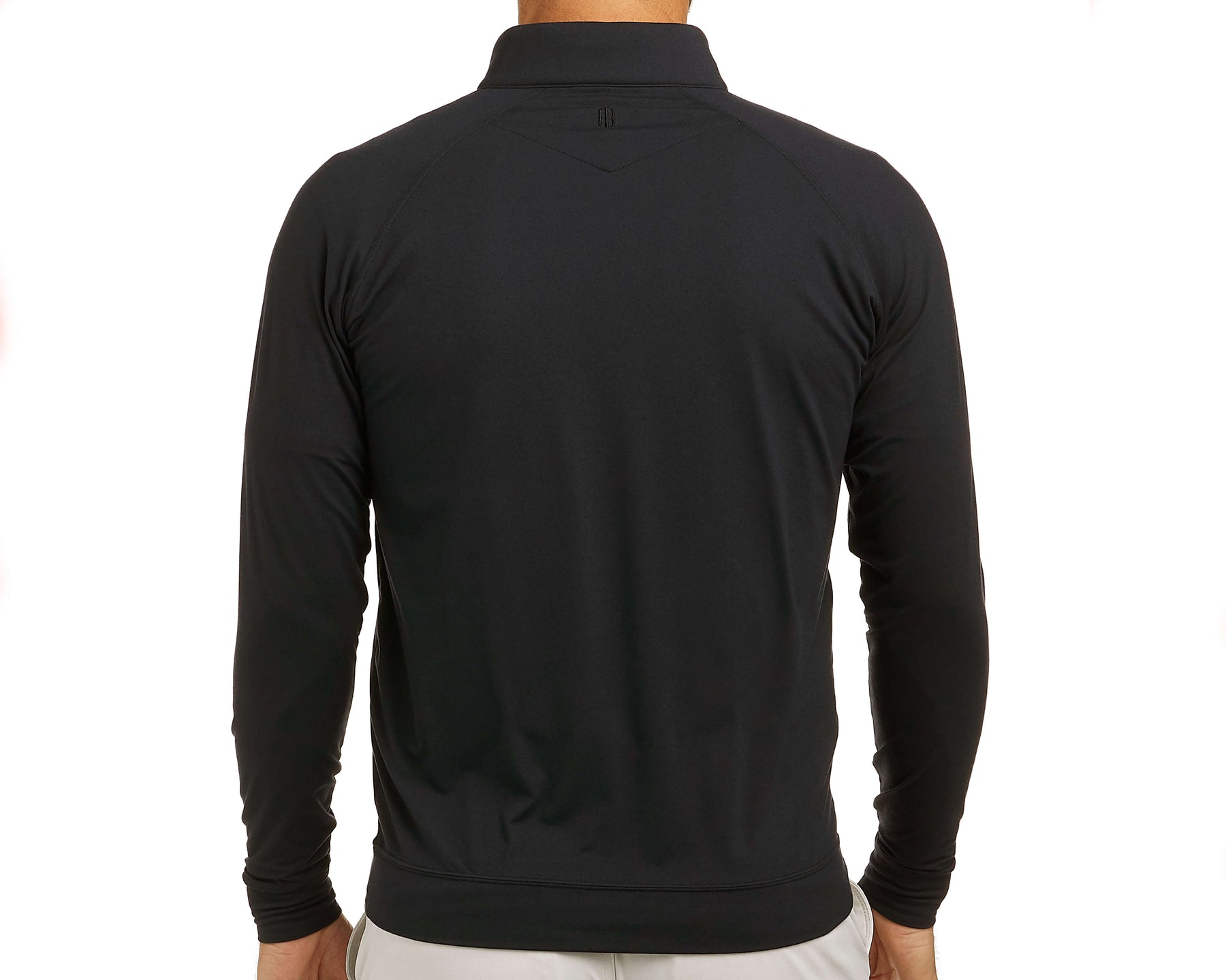 Back view of The Westland Quarter-Zip: Black, showcasing the fit and styling with a small logo below the collar, paired with light-colored bottoms.