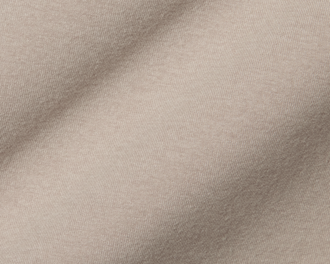 The Westland Quarter-Zip: Heathered Dune, showcasing its fine weave and soft folds, exemplifying moisture-wicking, peached synthetic blend fabric for versatile use.