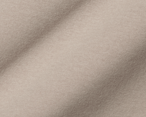 The Westland Quarter-Zip: Heathered Dune, showcasing its fine weave and soft folds, exemplifying moisture-wicking, peached synthetic blend fabric for versatile use.