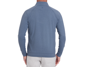 The Westland Quarter-Zip: Heathered Andover, showcasing a mock collar and long sleeves, worn by a model, highlights its athletic style and peached fabric texture.