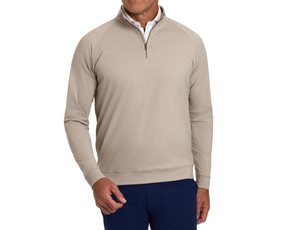 The Westland Quarter-Zip: Heathered Dune, worn over a white collared shirt, showcases its soft, moisture-wicking fabric with gunmetal chrome trim, ideal for versatile wear.