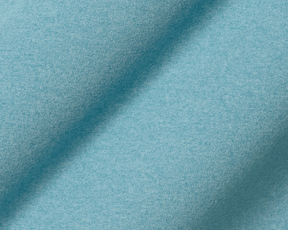 Close-up of The Westland Quarter-Zip: Heathered Harbor, showcasing its knit-textured, light blue fabric known for softness and moisture-wicking performance.
