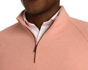 The Westland Quarter-Zip: Heathered Nectarine shown over a white shirt, highlighting its moisture-wicking fabric and gunmetal chrome trim for versatile wear.