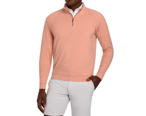 Model in The Westland Quarter-Zip: Heathered Nectarine, layered over a white shirt with light shorts, showcasing the pullover's soft, moisture-wicking fabric and chrome trim.