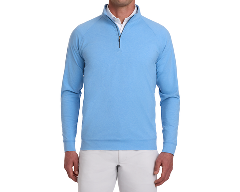 Model wearing The Westland Quarter-Zip in Heathered Vista Blue, showcasing its lightweight, moisture-wicking fabric with a soft, peached finish, over a white polo.
