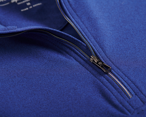 Close-up of The Westland Boys Quarter-Zip: Navy, highlighting the partially unzipped metal zipper on the soft, performance fabric with chrome accents.