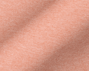 The Westland Quarter-Zip: Heathered Nectarine features soft, peach-colored knit fabric with fine weave and gentle folds, showcasing its lightweight, moisture-wicking properties.