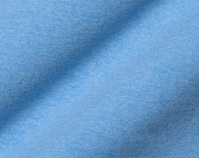 Close-up of The Westland Boys Quarter-Zip in Heathered Vista Blue, showcasing its soft, light-blue knit fabric with a gentle drape.