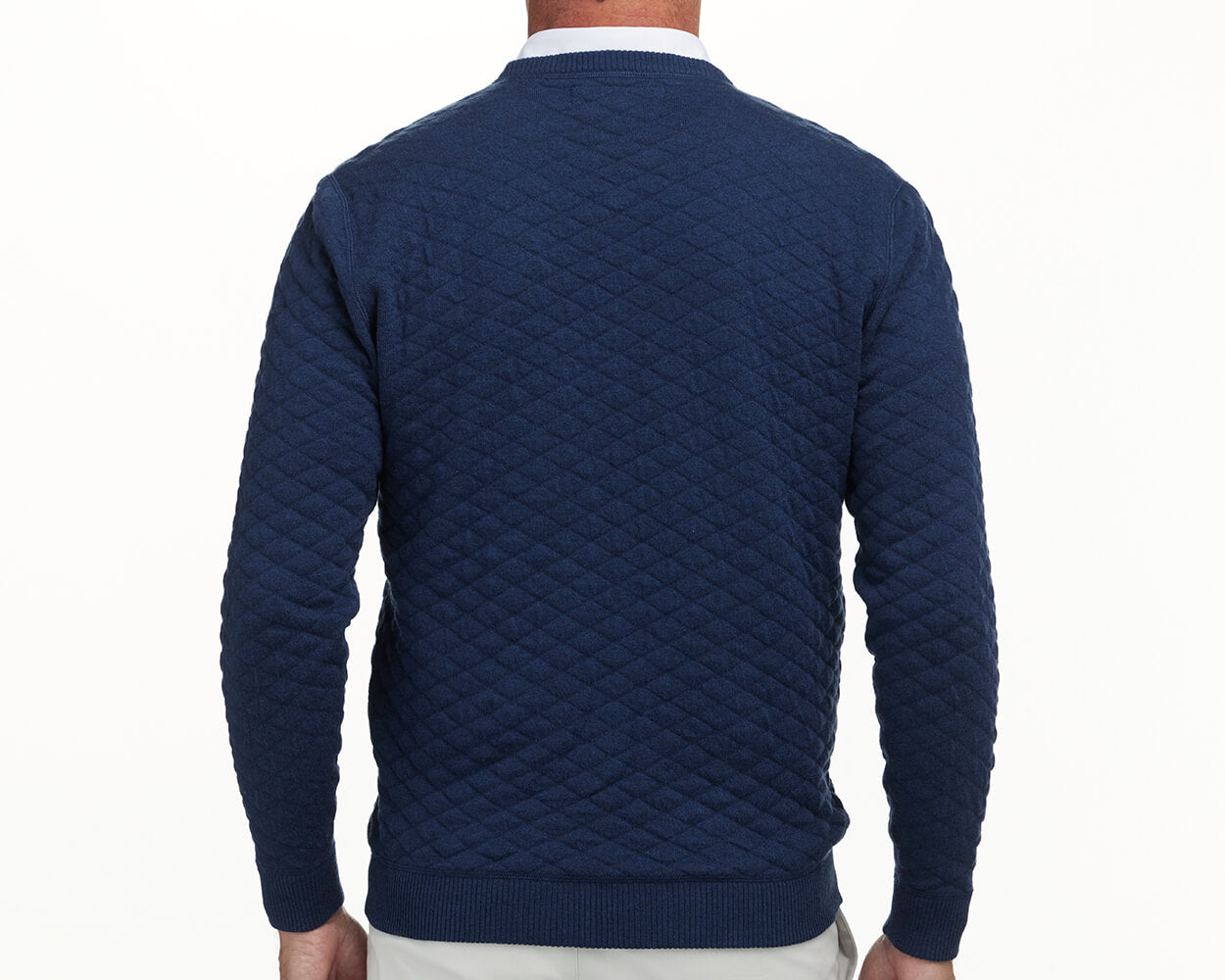 The Ward Crewneck Sweater: Heathered Navy, featuring a diamond-quilted pattern, worn over a white collared shirt, showcasing its premium Egyptian cotton texture.