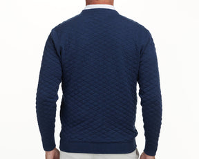 The Ward Crewneck Sweater: Heathered Navy, featuring a diamond-quilted pattern, worn over a white collared shirt, showcasing its premium Egyptian cotton texture.