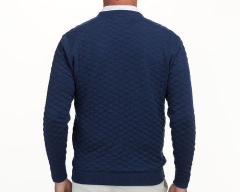 The Ward Crewneck Sweater: Heathered Navy, featuring a diamond-quilted pattern, worn over a white collared shirt, showcasing its premium Egyptian cotton texture.