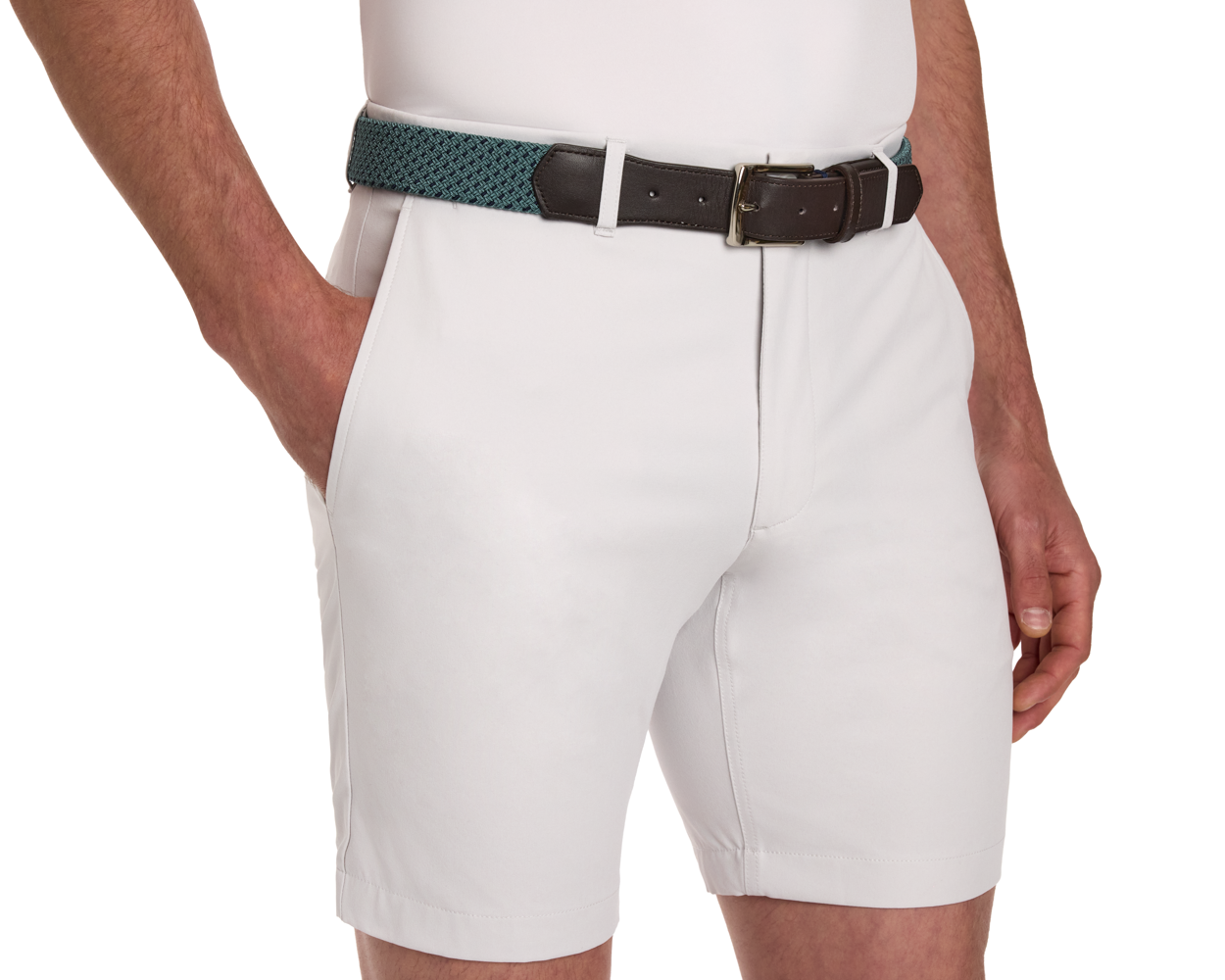 The Fischer Belt: Dark Harbor & Navy Basketweave shown on light-colored tailored shorts, featuring a woven teal design with leather ends and a brass-tone buckle.