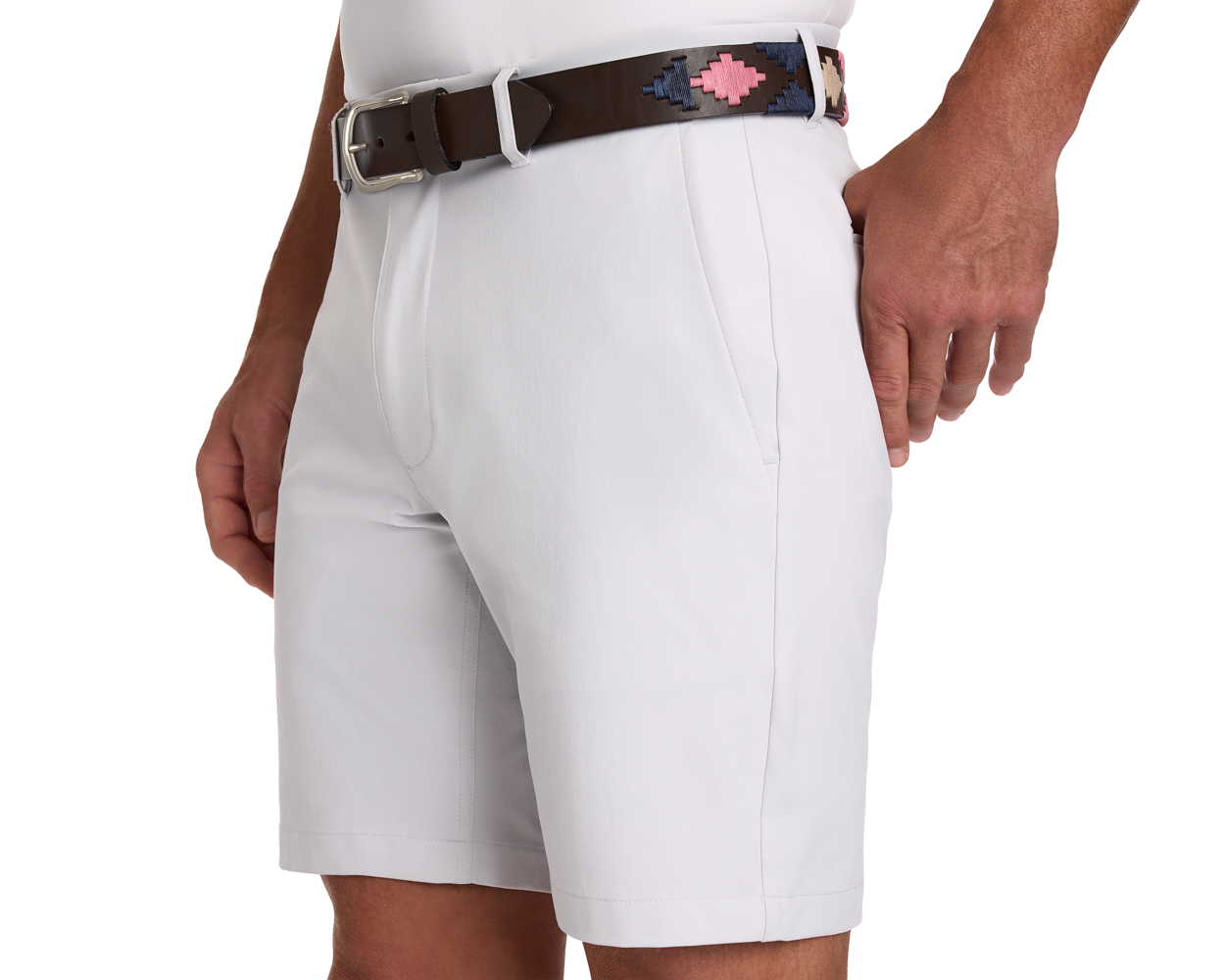 Man wearing light gray shorts with The Barker Belt—a dark brown leather belt featuring a woven navy and pink geometric pattern, showcasing Argentinean-inspired craftsmanship.