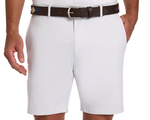 The Barker Belt in brown on white shorts, features intricate Argentinean-inspired patterns, showcasing premium craftsmanship and style.