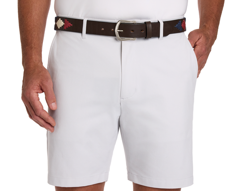 The Barker Belt: Brown/Navy/Claret/Stone, handcrafted leather with silver buckle, showcases Argentinean-inspired patterns, worn with light shorts and a tucked-in white shirt.