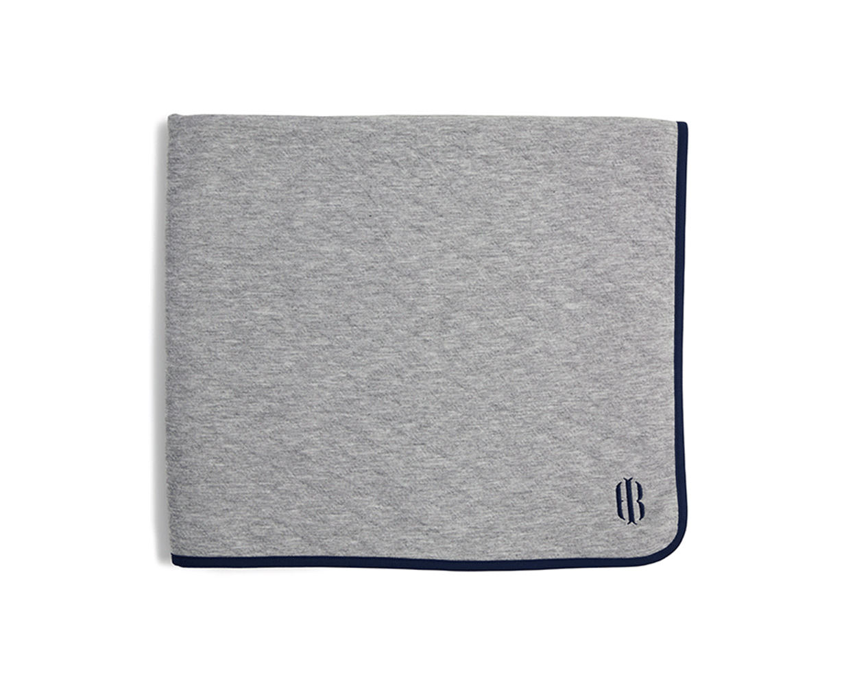 The Van Pelt Blanket: Heathered Gray with navy trim and embroidered logo, folded, showcasing its cozy, quilted fabric ideal for warmth and style.