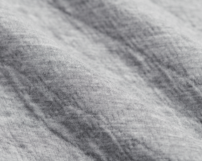 The Van Pelt Blanket: Heathered Gray, close-up of soft, knit fabric texture, showcasing its looped weave, ideal for cozy, stylish comfort.
