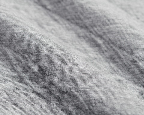 The Van Pelt Blanket: Heathered Gray, close-up of soft, knit fabric texture, showcasing its looped weave, ideal for cozy, stylish comfort.