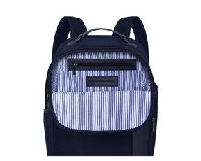 The Broughton Backpack: Navy Ballistic, features an unzipped front pocket revealing a striped lining, zippered inner pocket, and leather patch stamped “HOLDENNESS & BOURNE.”