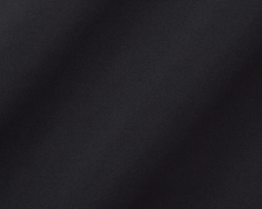The Farrell Shirt: Black, close-up of textured performance jersey fabric with subtle folds, featuring long sleeves, spread collar, and contrast piping for versatile comfort and style.