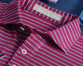 The Springer Shirt: Cabernet/White/Horizon Blue, featuring a collared, button-front design with narrow stripes, woven label “Holderness & Bourne,” and breathable AIRATION® fabric.