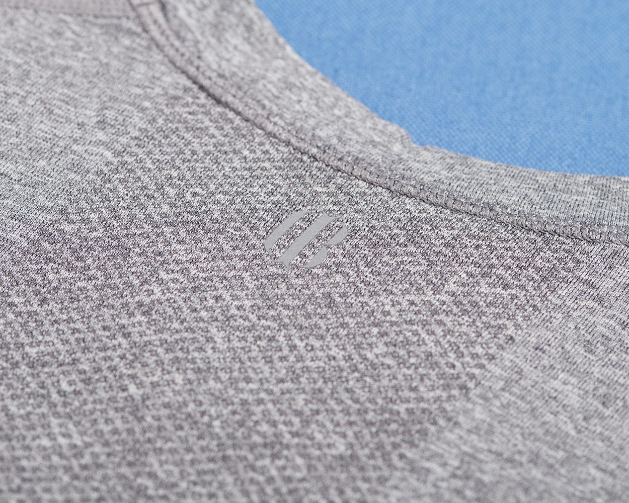 The Pickett Performance T-Shirt: Heathered Gray, showcasing fine two-tone texture, reinforced collar stitching, and minimalist logo; crafted with breathable AIRATION® fabric for comfort and athletic performance.