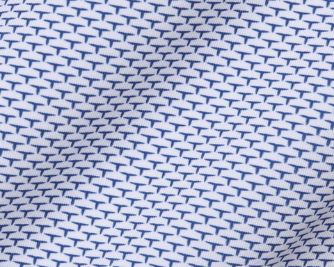 Close-up of the Yale Golf Course Armfield Shirt: Andover, showcasing its white fabric with blue “T”-shaped motifs, highlighting its geometric pattern and premium performance features.