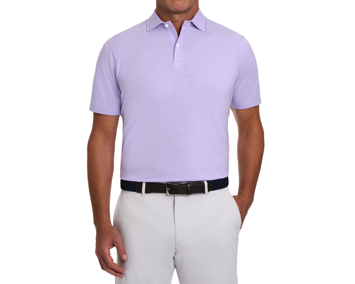 Man wearing The Hatcher Shirt: Tudor & White, a short-sleeve polo with a structured collar, tucked into trousers, accessorized with a woven belt.