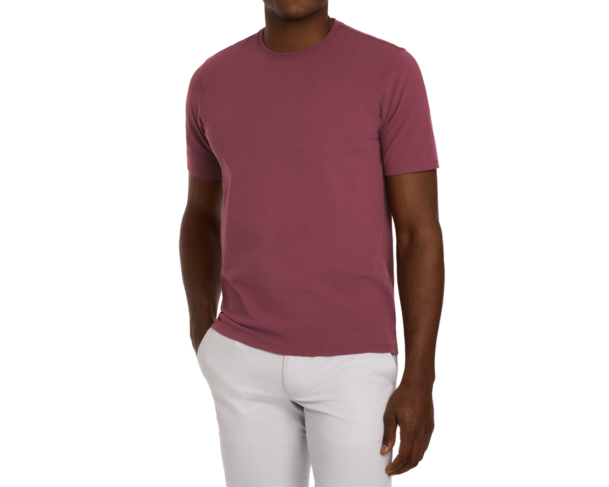 The Mason T-Shirt: Cabernet in muted burgundy features short sleeves, crew neck, midweight Peruvian pima cotton, paired with light gray trousers.