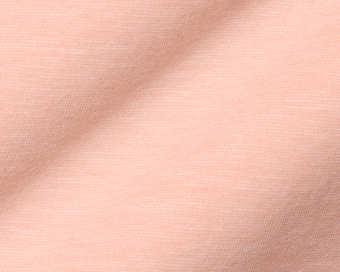Close-up of The Hatcher Shirt: Nectarine & White, highlighting its soft knit fabric with a textured weave, showcasing comfort and stretch.