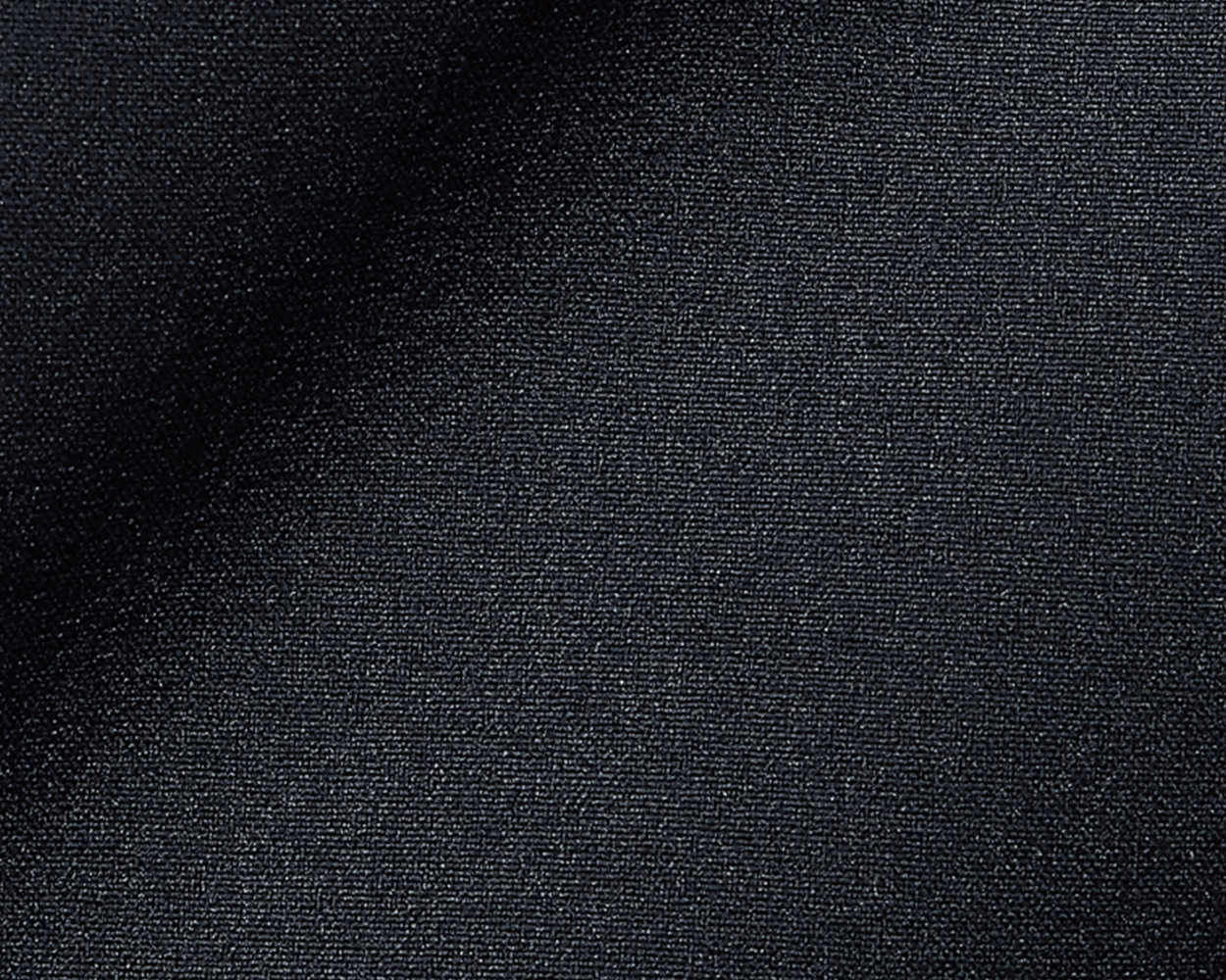 Close-up of The Harwood Short: Black, showcasing its dark, tightly woven fabric with a slight drape, highlighting the soft, stretchable performance material.