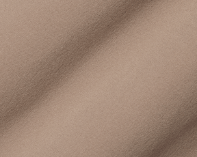 Close-up of The McDaniel 5 Pocket Pant: Fescue, showing its tan-beige woven fabric with fine weave and gentle folds, highlighting its performance and comfort features.