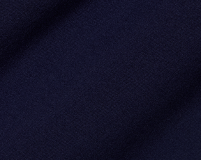 Close-up of The McDaniel 5 Pocket Pant: Navy, showcasing its fine woven texture, highlighting wrinkle-resistant, quick-dry performance fabric with eco-friendly recycled polyester and elastane blend.